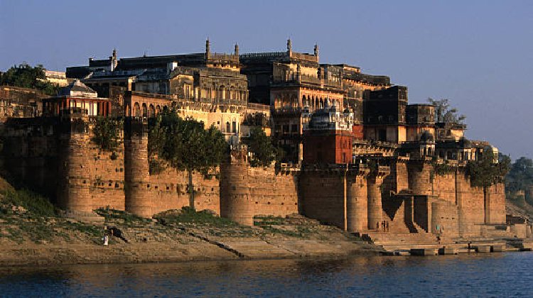 A scenic view of Varanasi showcasing its famous temples and vibrant ghats, highlighting popular tourist places in Kashi, with visitors exploring the best spots to visit in Varanasi.