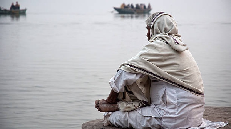 A scenic view of Varanasi, showcasing the ghats and the Ganges River, with a focus on the best time to visit, including ideal months for travel and a glimpse of the city's weather.