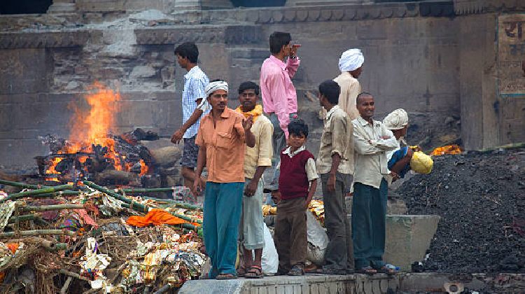 A scenic view of Varanasi, showcasing the ghats and the Ganges River, with a focus on the best time to visit, including ideal months for travel and a glimpse of the city's weather.